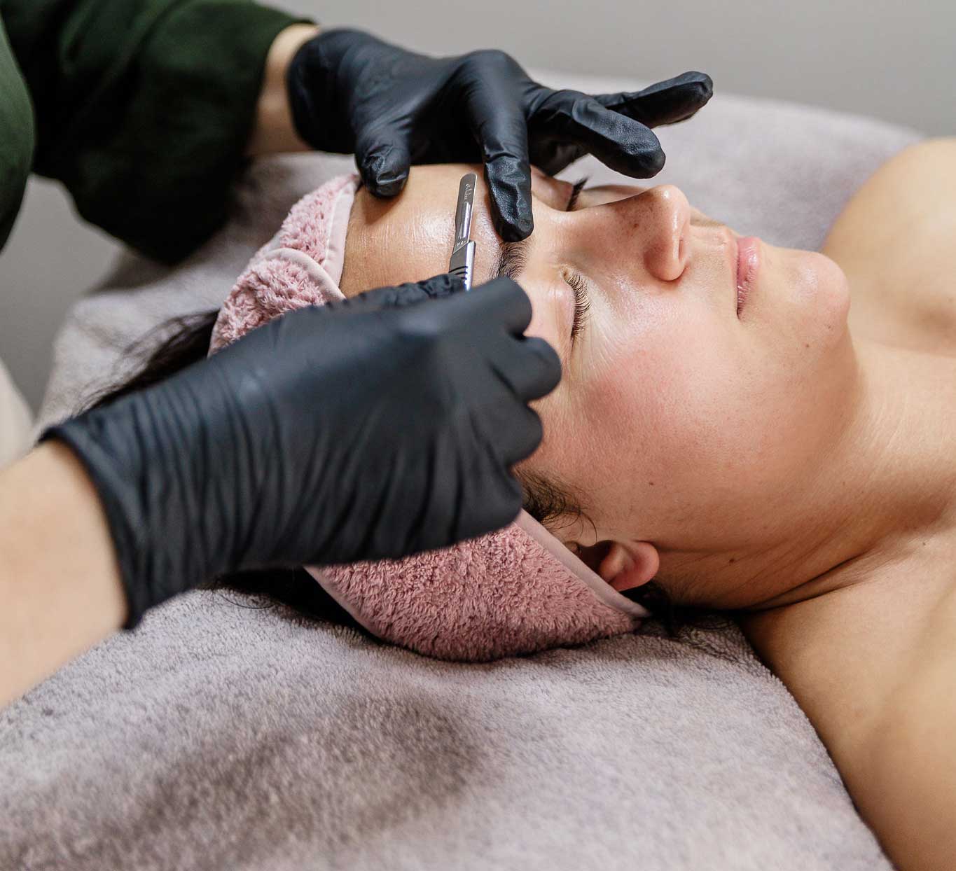 Lady relaxing getting a glowing skin Dermaplaning facial treatment